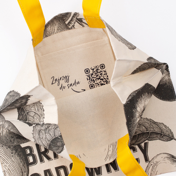 Close-up of the branded inside pocket and QR code in a custom natural cotton tote bag.