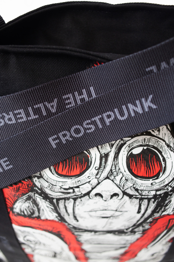 Detail of a Frostpunk tote bag featuring custom black handles and red, white and black artwork.